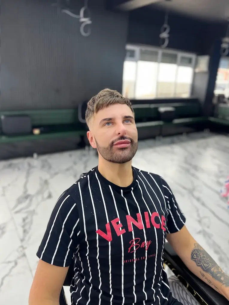 Textured crop with a low fade and a shaped beard, face on, at HAWAR BARBER in Darlington